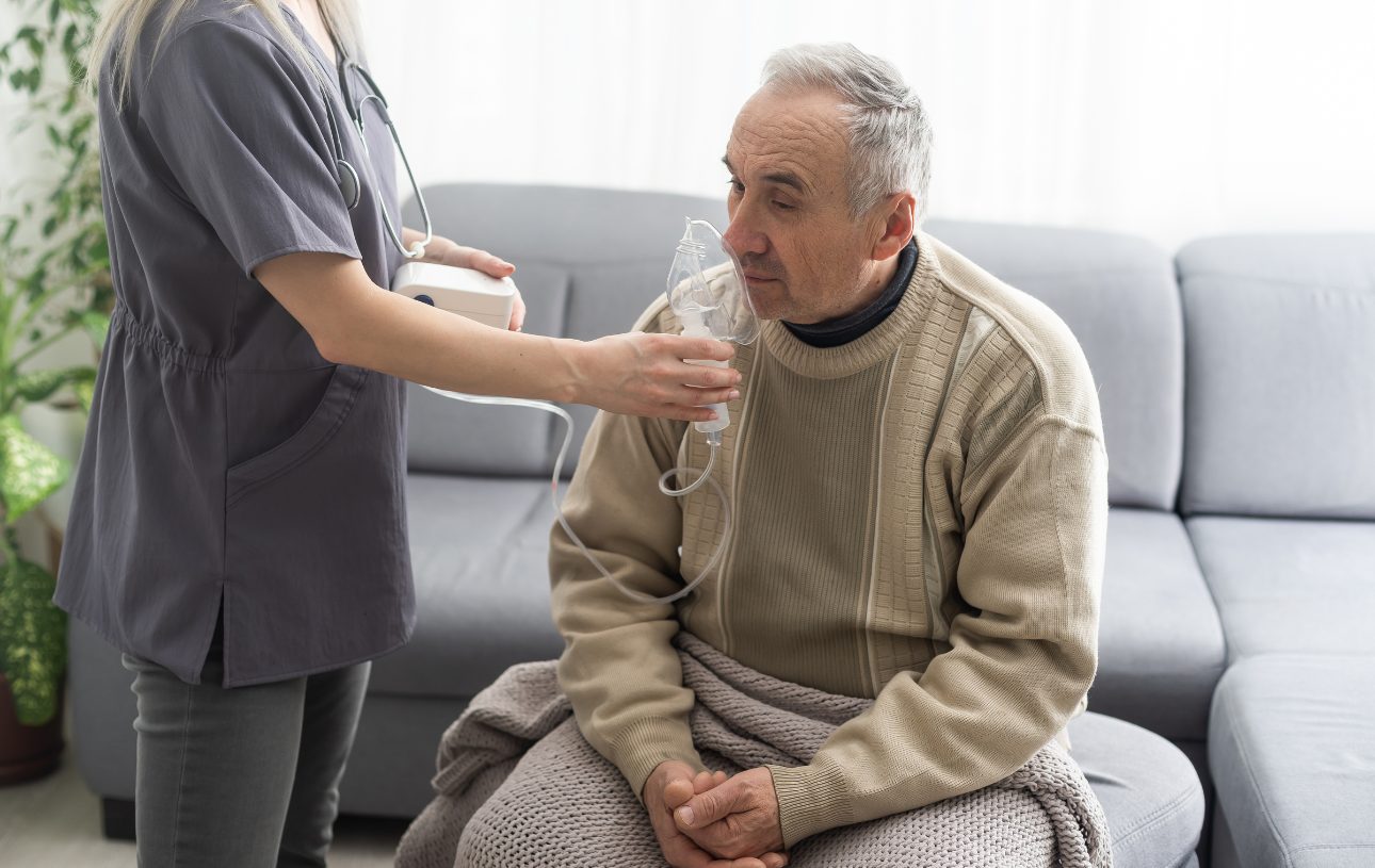 nurse giving man an oxygen mask